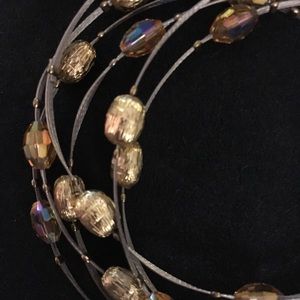 Bangles (6) with gold and amber colored beads